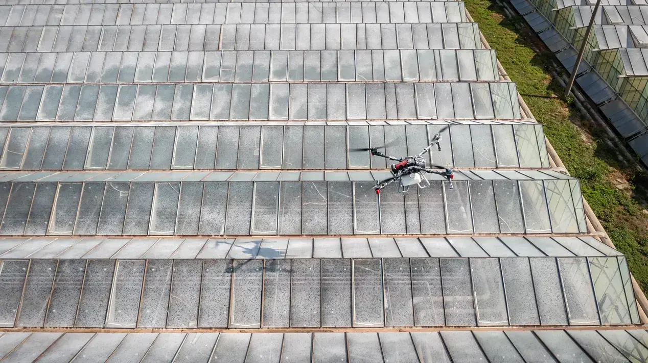 Drone shading a large greenhouse