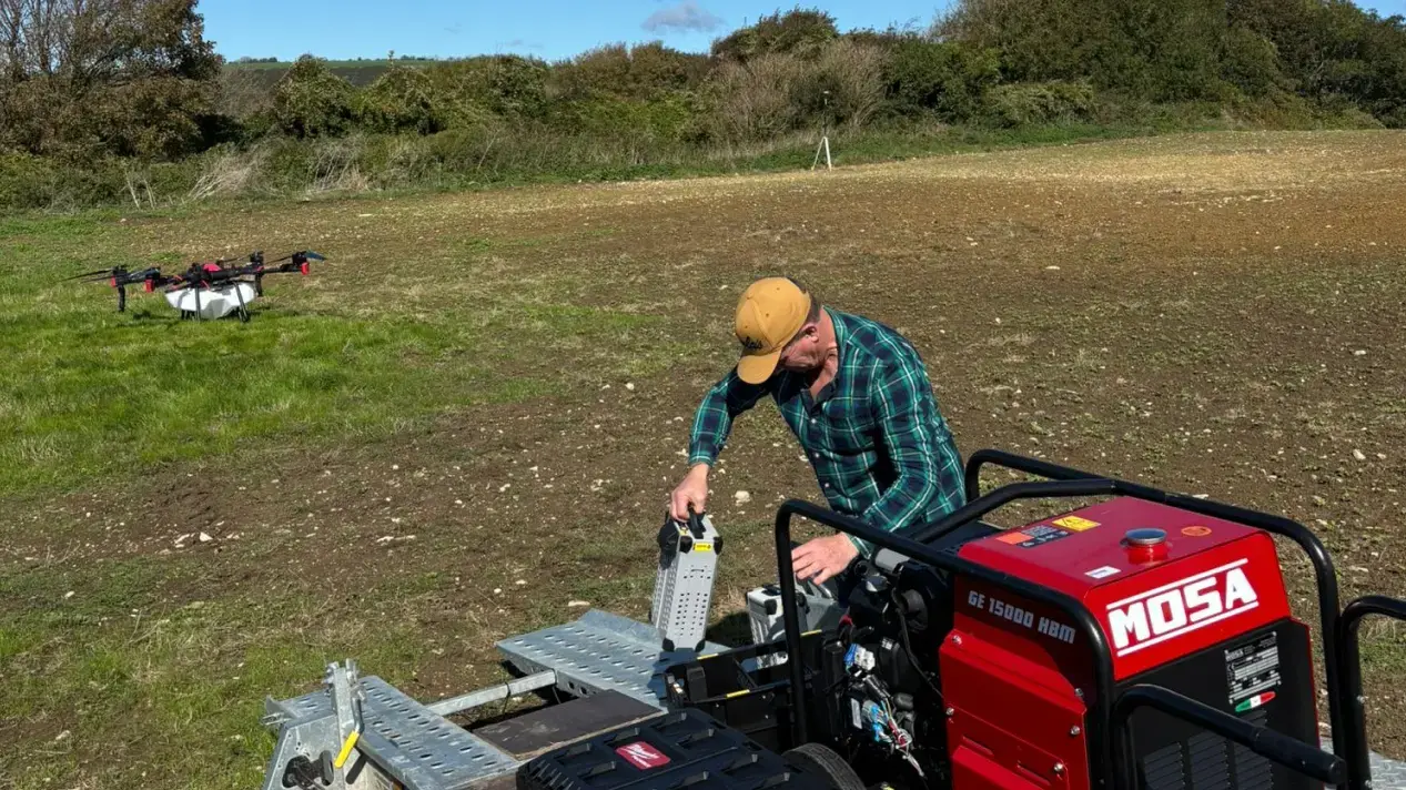 Ben prepares an agricultural drone for fertiliser application on a UK farm.